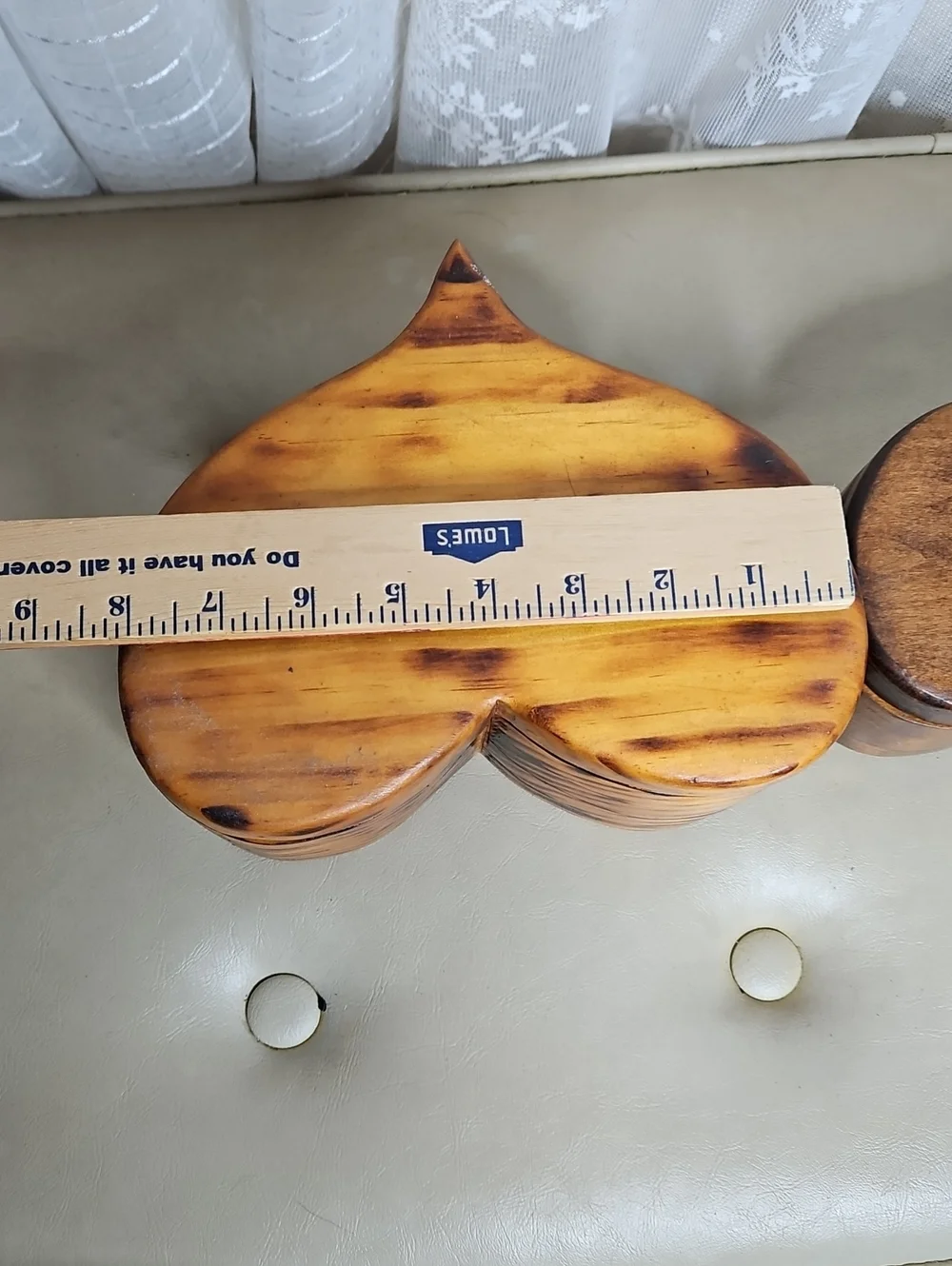 Two handmade, heart-shaped wooden boxes with visible grain patterns